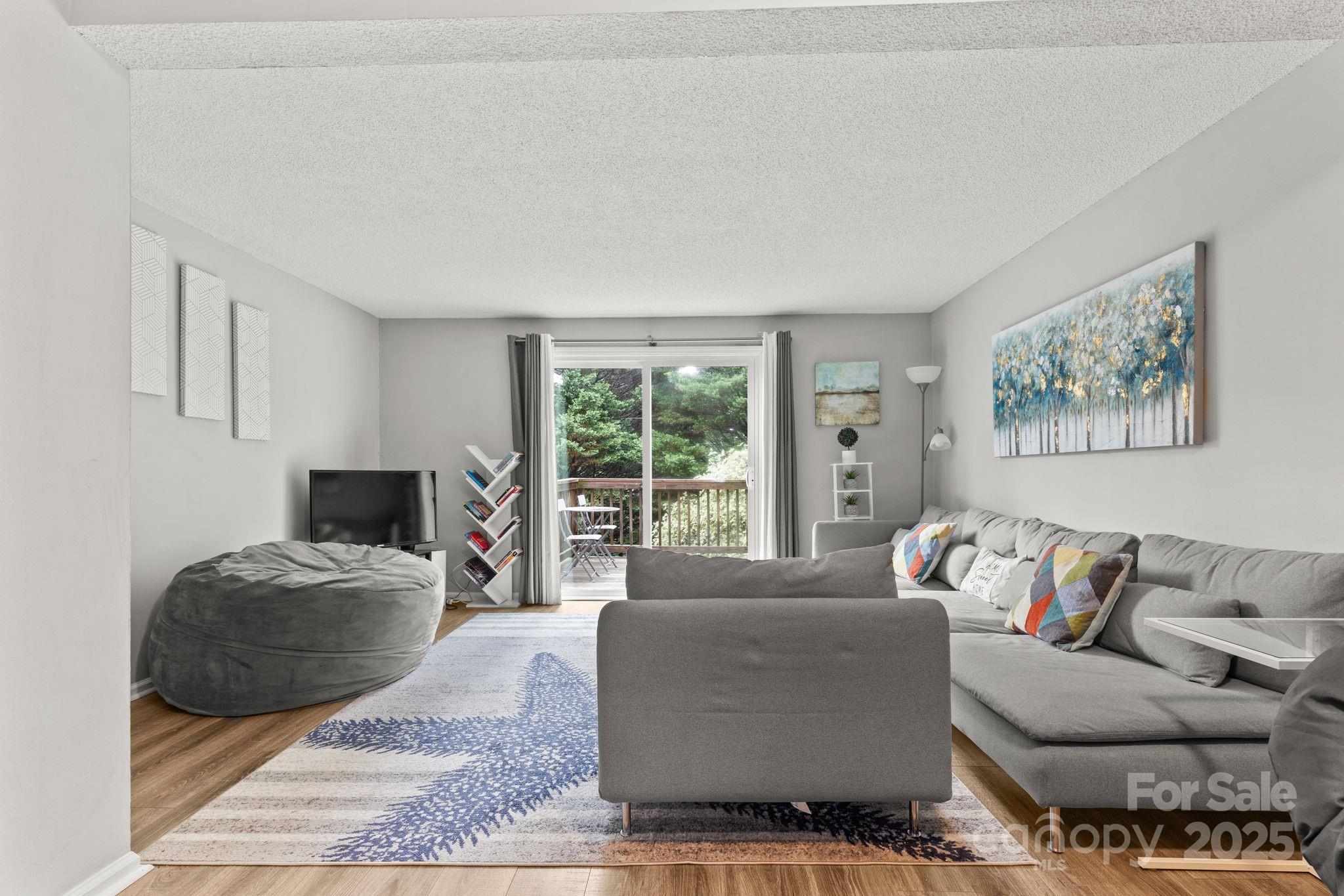 9606 Vinca Circle, Unit E Charlotte, NC 28213 - Photo 10 of 26 a living room with furniture and a large window