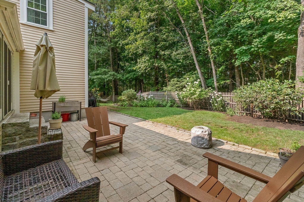 33 Bare Hill Road Topsfield, MA 01983 - Photo 26 of 40 a view of a backyard with chairs potted plants and a wooden bench