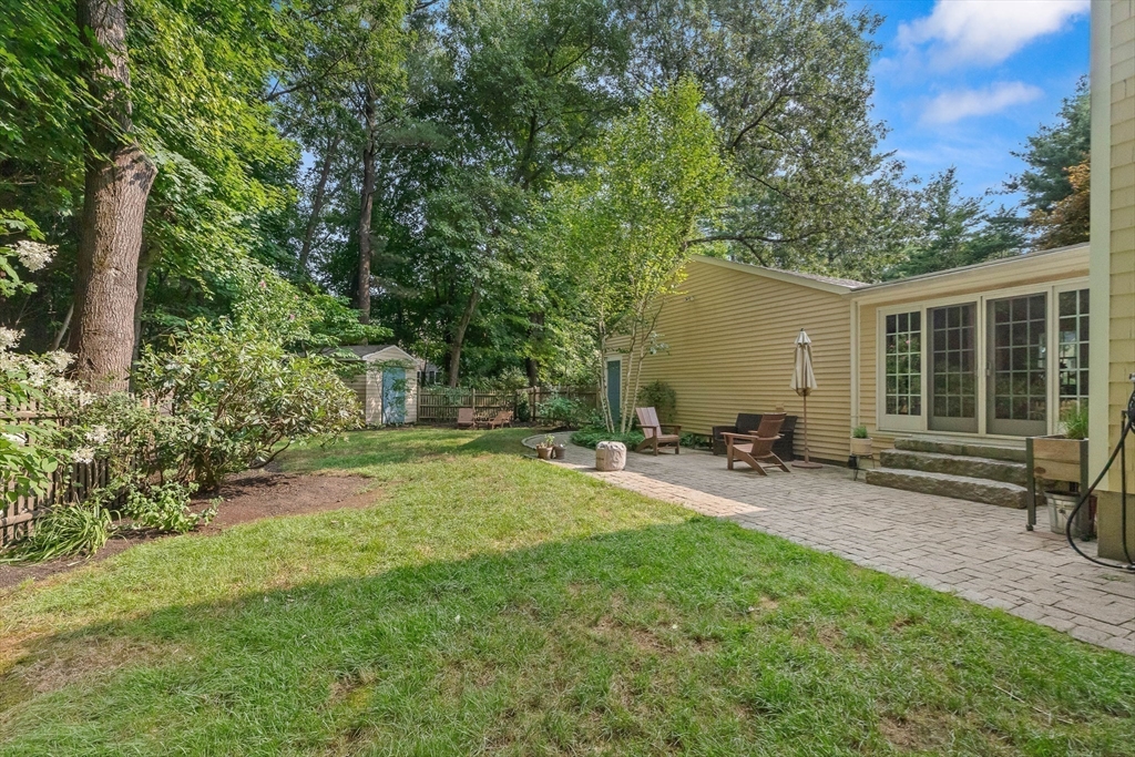 33 Bare Hill Road Topsfield, MA 01983 - Photo 31 of 40 a view of a backyard with table and chairs and potted plants and large tree