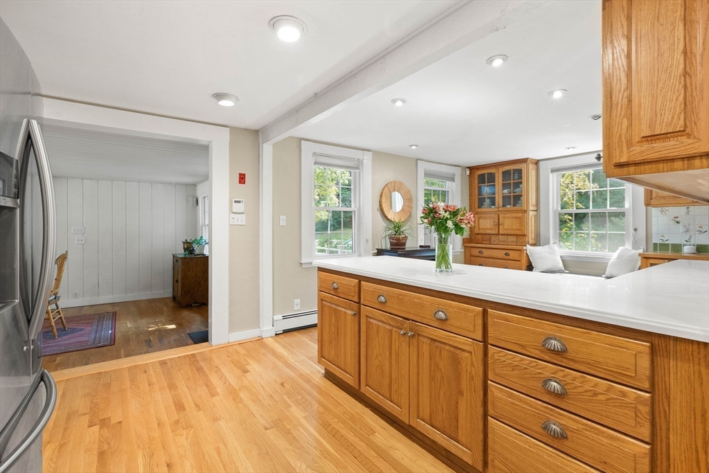 33 Bare Hill Road Topsfield, MA 01983 - Photo 5 of 40 a spacious bathroom with a granite countertop sink and a mirror
