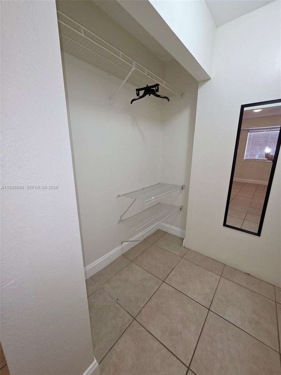 10451 Southwest 157th Place, Unit 305 Miami, FL 33196 - Photo 13 of 23 a view of an empty walk in closet