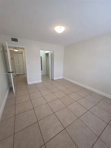 a view of an empty room and wooden floor