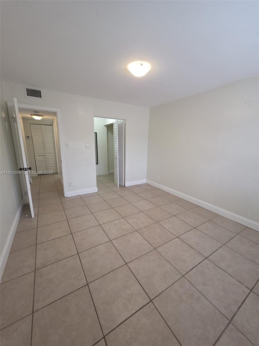 10451 Southwest 157th Place, Unit 305 Miami, FL 33196 - Photo 16 of 23 a view of an empty room and wooden floor