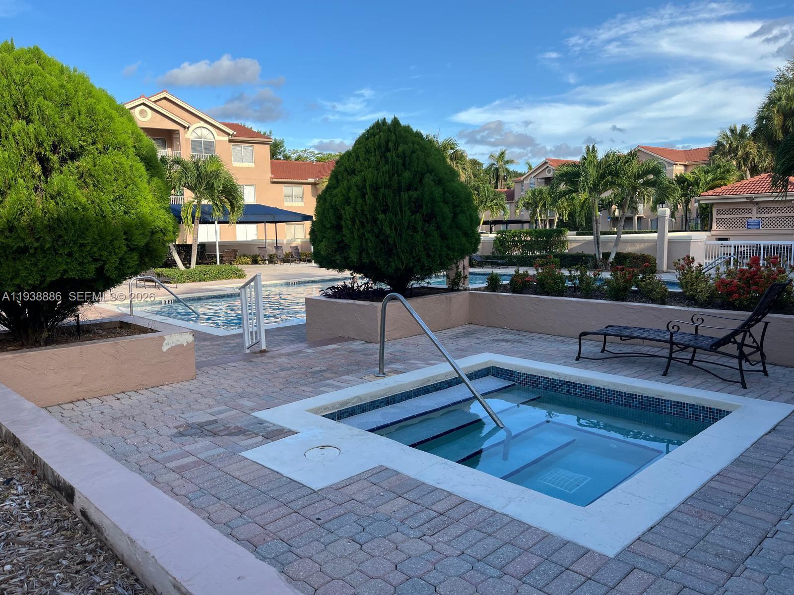 10451 Southwest 157th Place, Unit 305 Miami, FL 33196 - Photo 18 of 23 a view of a terrace with sitting area
