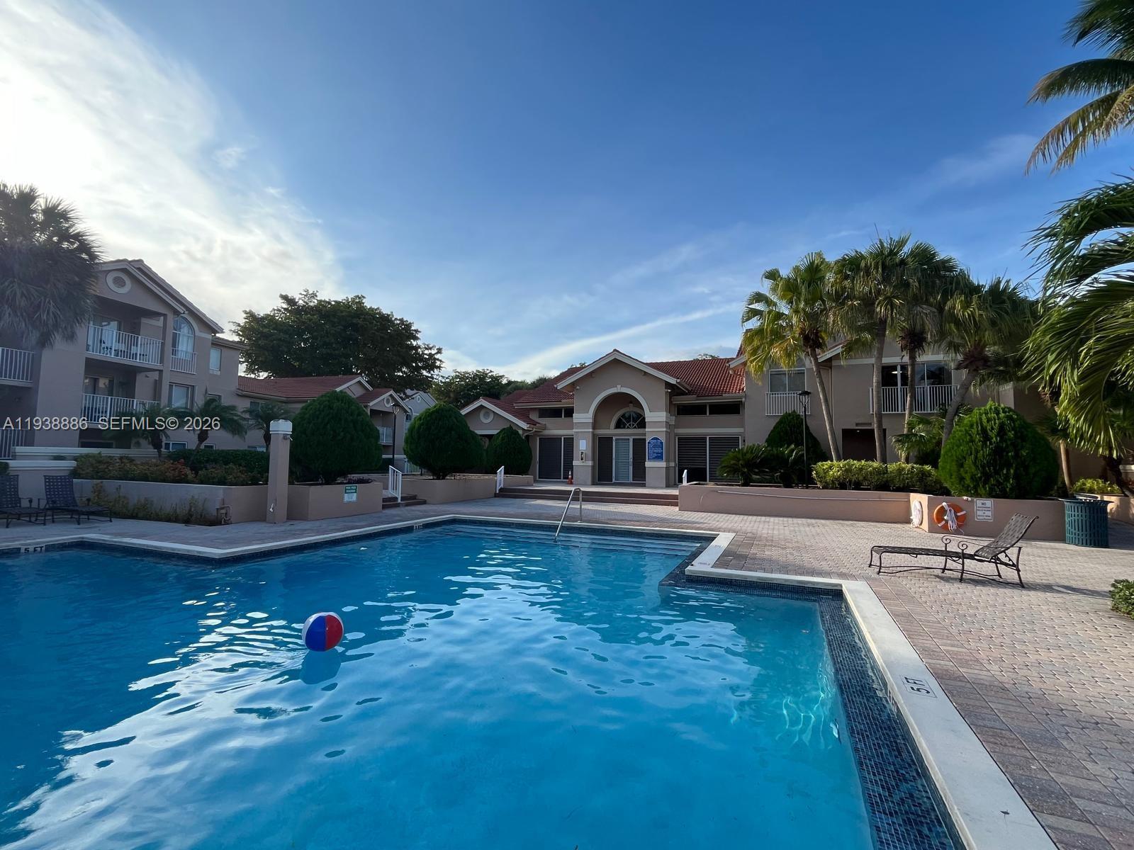 10451 Southwest 157th Place, Unit 305 Miami, FL 33196 - Photo 20 of 23 a view of a swimming pool with lounge chair