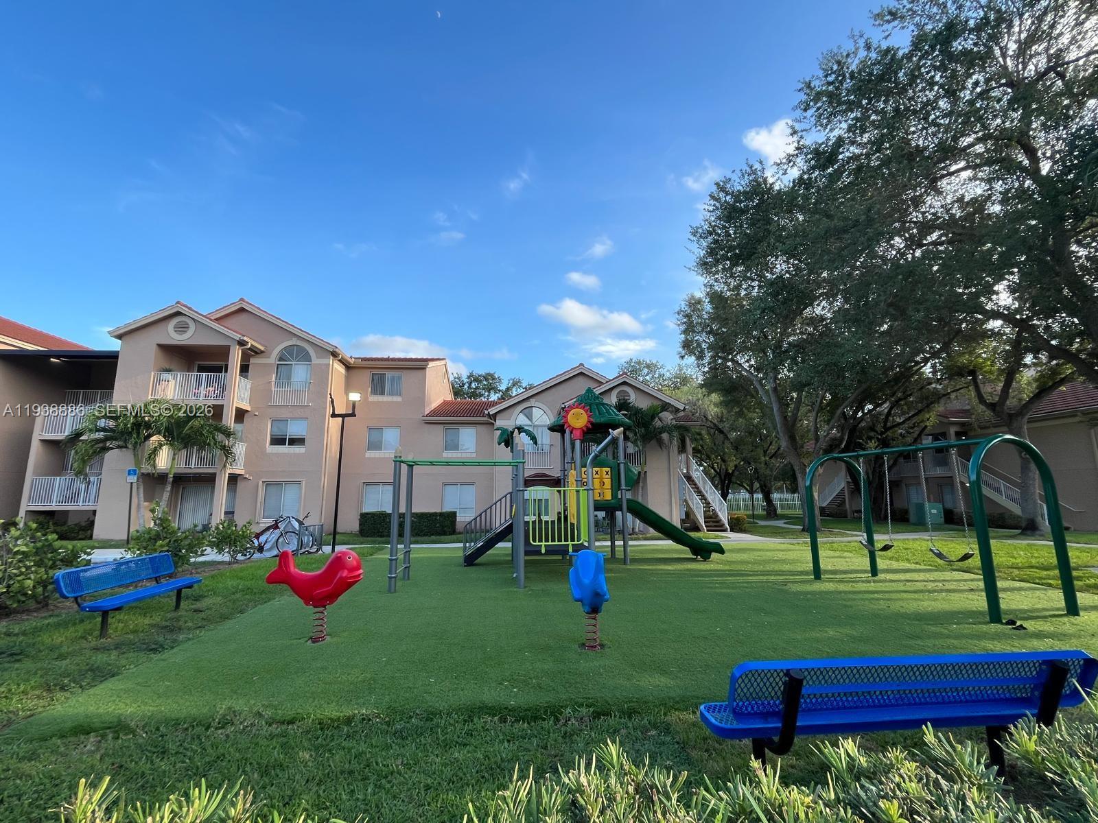 10451 Southwest 157th Place, Unit 305 Miami, FL 33196 - Photo 21 of 23 a view of a park with large trees