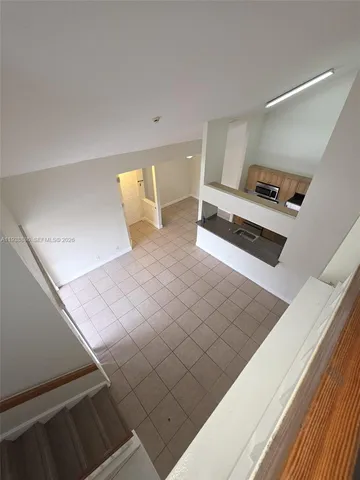 a view of a living room with furniture and a rug