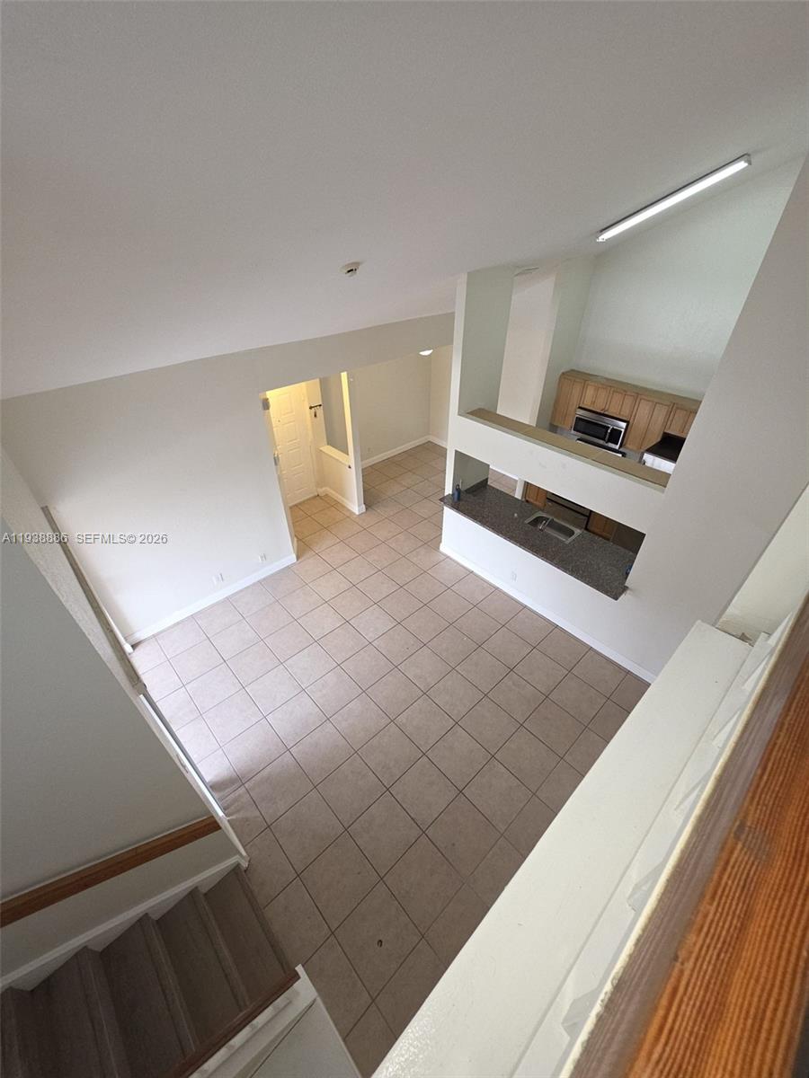 10451 Southwest 157th Place, Unit 305 Miami, FL 33196 - Photo 9 of 23 a view of a living room with furniture and a rug