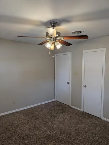 a view of a chandelier fan in a room