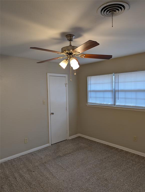 5521 Odessa Avenue Fort Worth, TX 76133 - Photo 16 of 21 an empty room with windows and fan