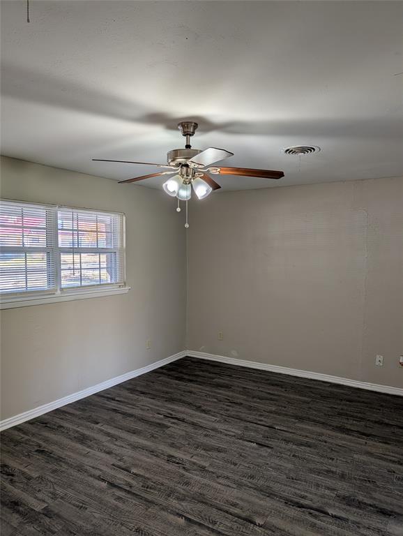 5521 Odessa Avenue Fort Worth, TX 76133 - Photo 3 of 21 a view of an empty room with wooden floor and a window