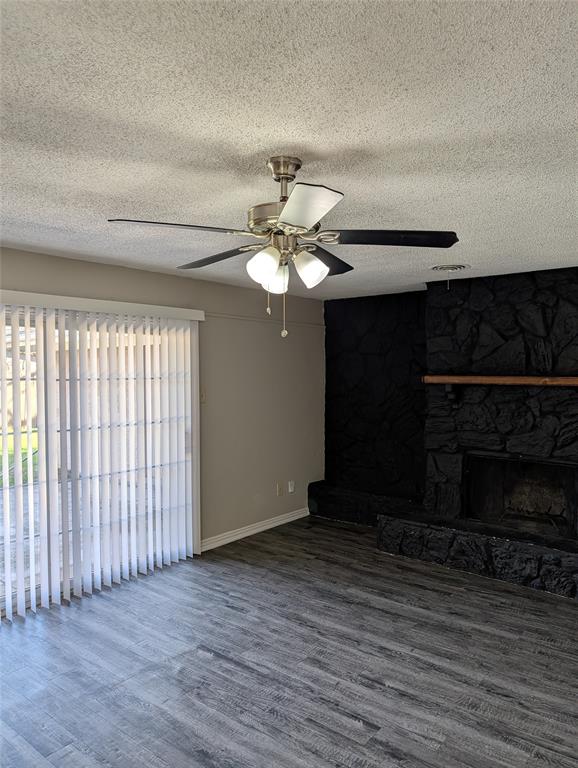 5521 Odessa Avenue Fort Worth, TX 76133 - Photo 6 of 21 wooden floor in an empty room with a fireplace