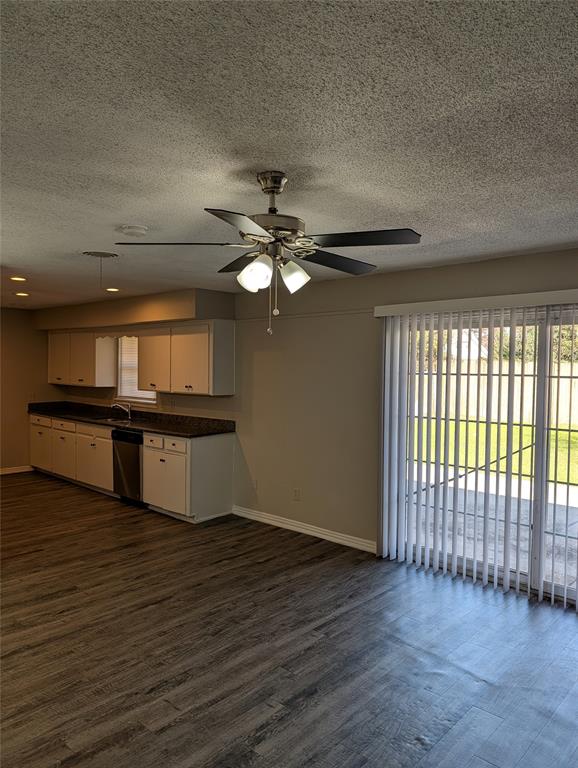 5521 Odessa Avenue Fort Worth, TX 76133 - Photo 7 of 21 an empty room with wooden floor fan and windows