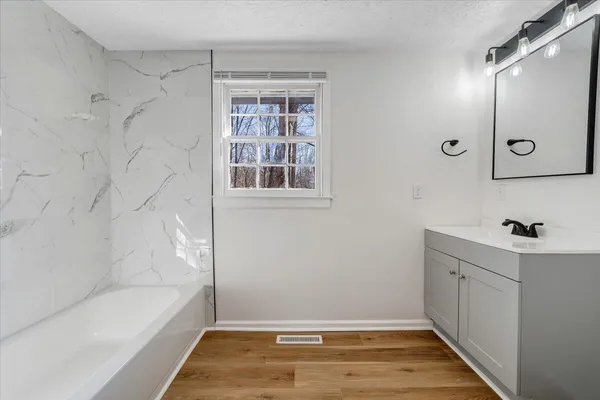 a bathroom with a bathtub and a shower