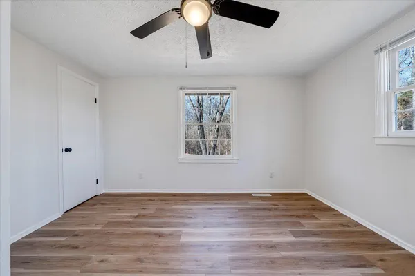 wooden floor in an empty room with a window