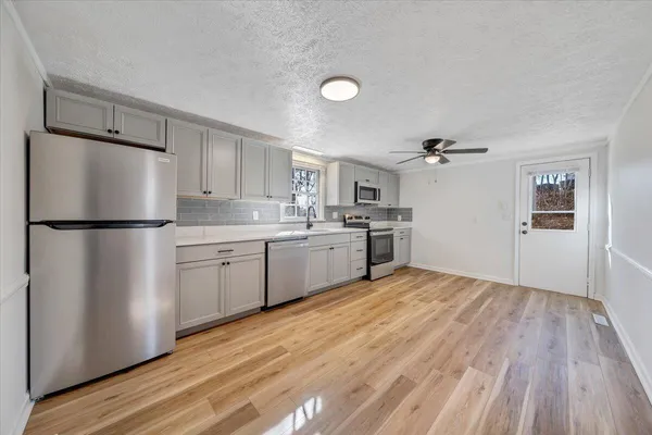 a kitchen with a refrigerator a sink and dishwasher