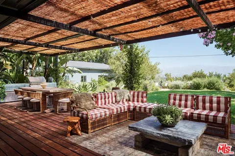 a view of patio with table and chairs and potted plants