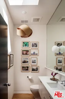 a bedroom with a bed a bookshelf and a window