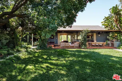a view of a swimming pool with a patio and plants