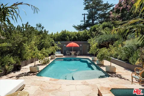 a swimming pool with outdoor seating and yard