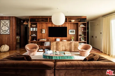 a living room with furniture and a mirror