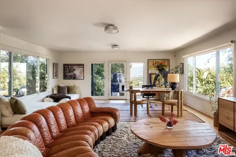 a view of a workspace with furniture window and outside view