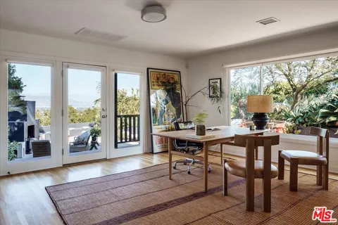 a view of a backyard with plants and a mountain