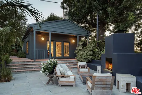 a view of a yard with plants and trees