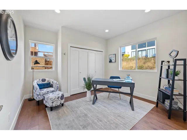 a bedroom with furniture and a wooden floor
