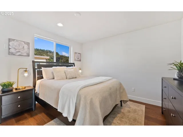 a spacious bedroom with a bed and a window