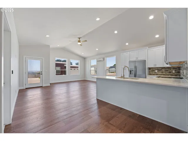 a view of kitchen with refrigerator and window