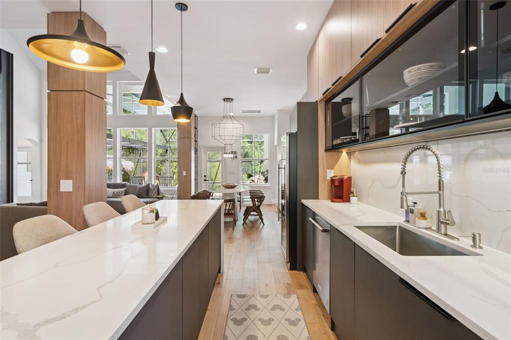 908 Croton Road Celebration, FL 34747 - Photo 24 of 86 a large kitchen with kitchen island a large window a sink and stainless steel appliances
