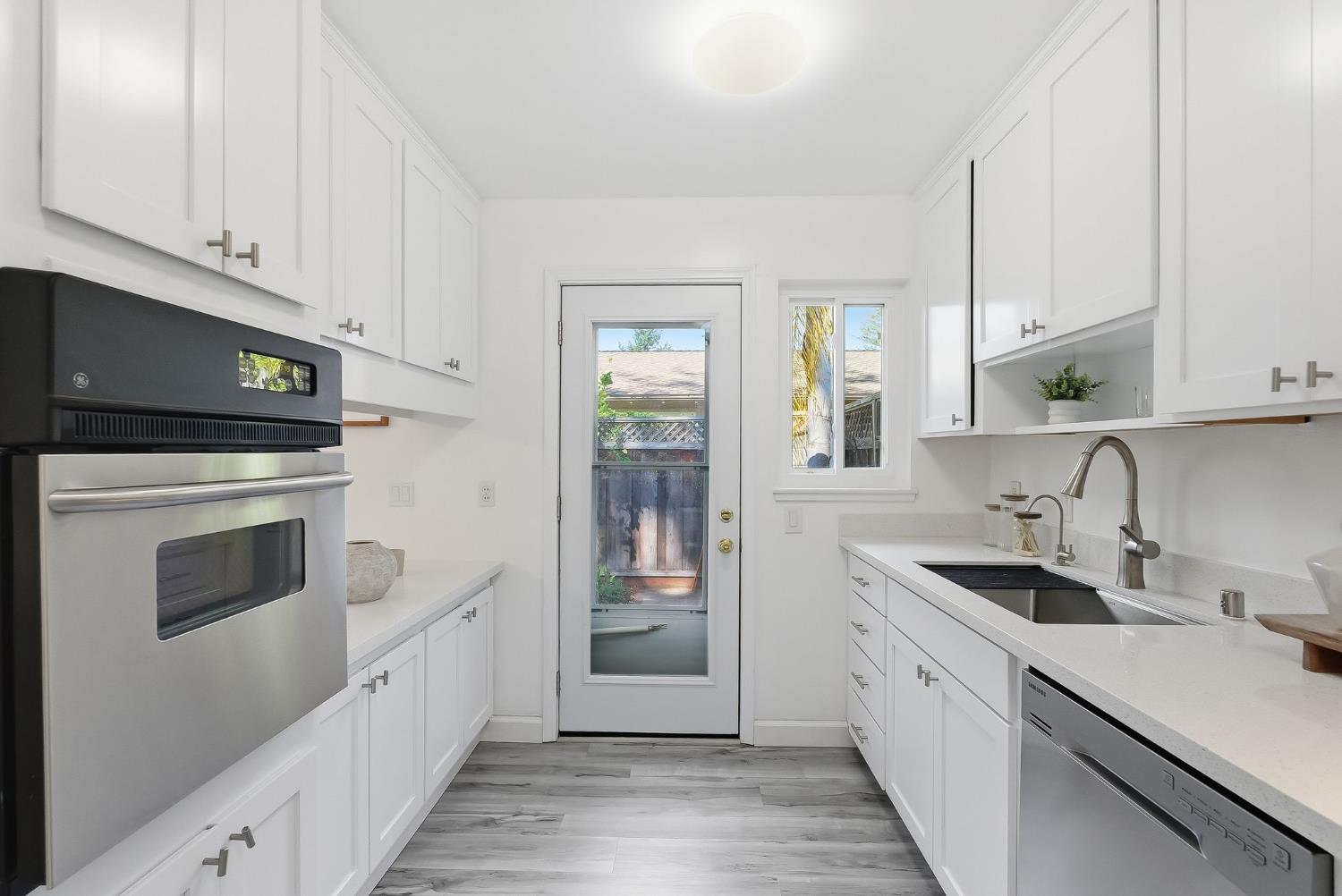 672 North San Antonio Road Los Altos, CA 94022 - Photo 11 of 22 a kitchen with granite countertop white cabinets and white appliances