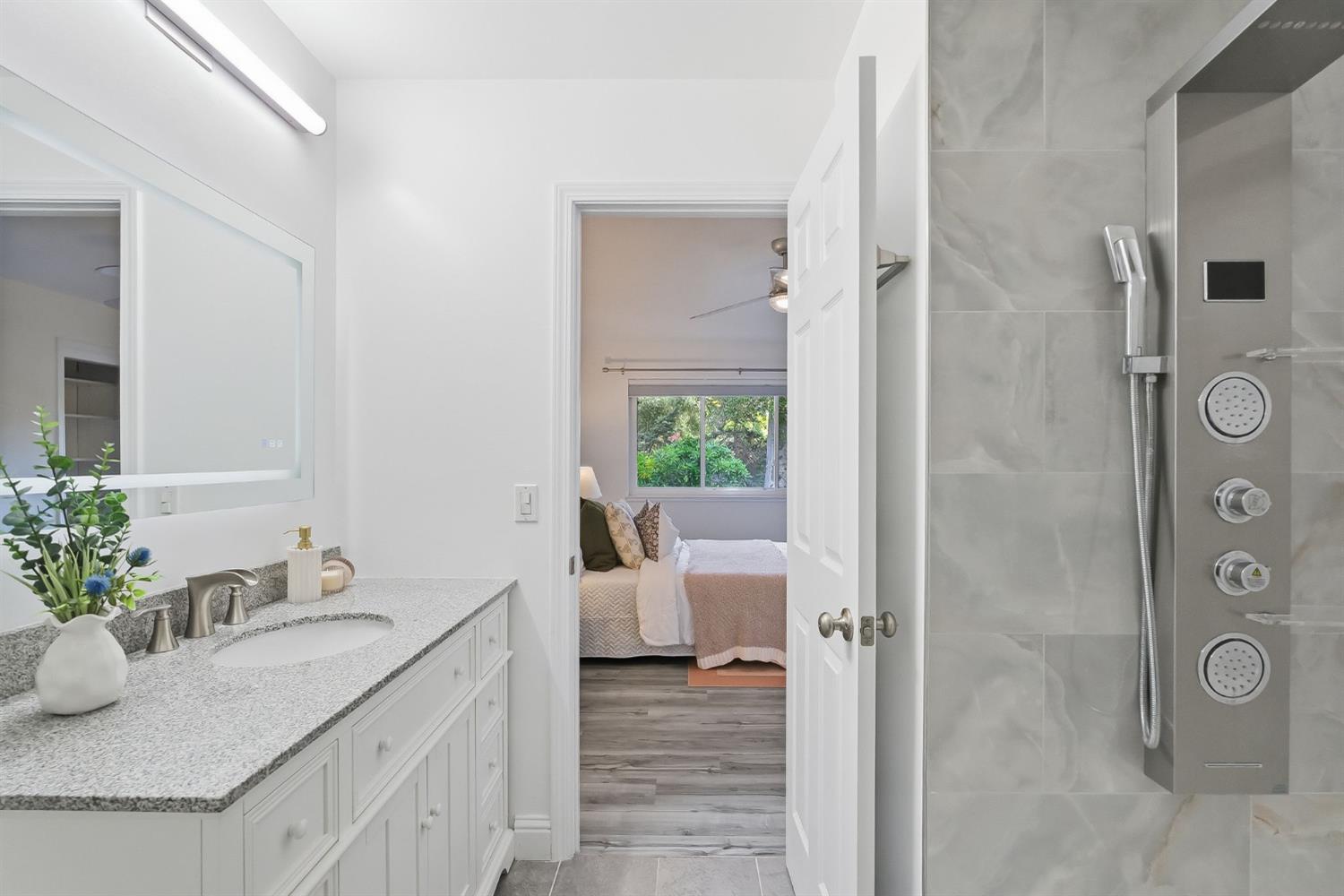 672 North San Antonio Road Los Altos, CA 94022 - Photo 16 of 22 a bathroom with a granite countertop sink and a mirror