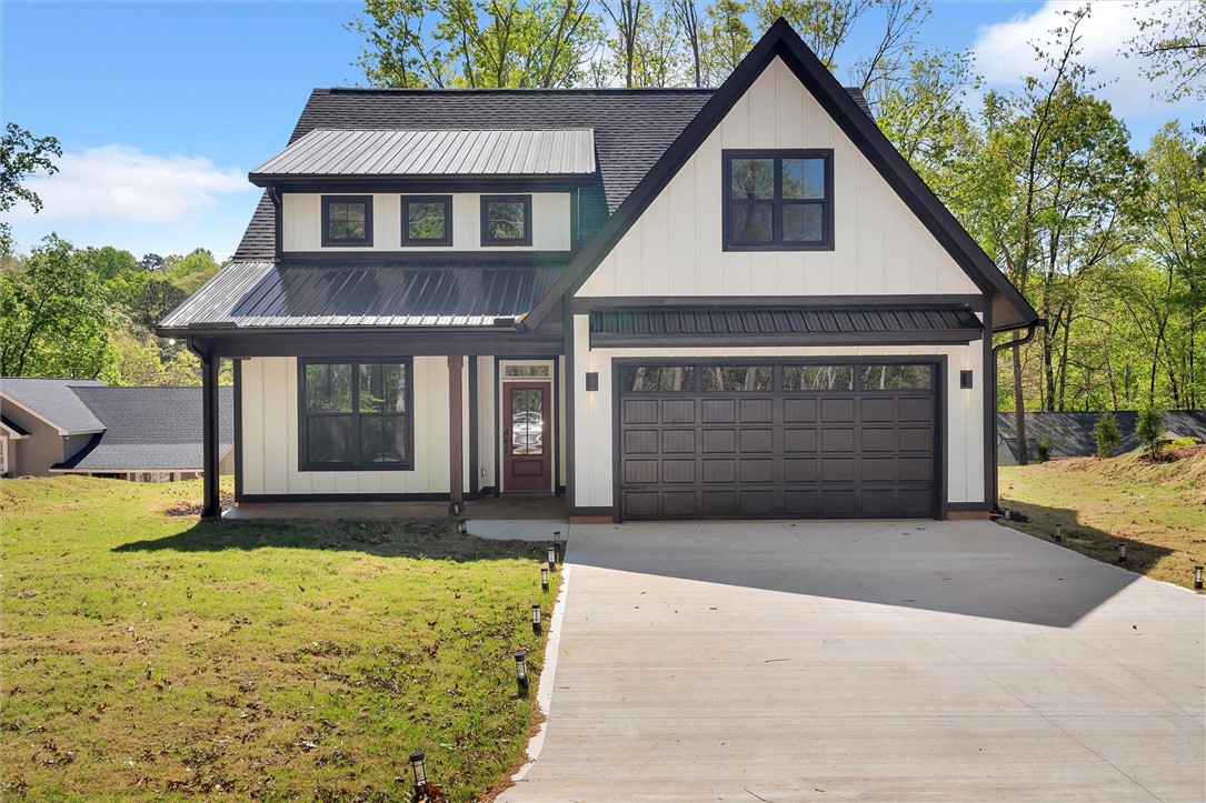 407 Blue Ridge Court Westminster, SC 29693 - Photo 41 of 48 This charming modern farmhouse features a sleek black and white exterior, with a spacious garage and welcoming front entry.