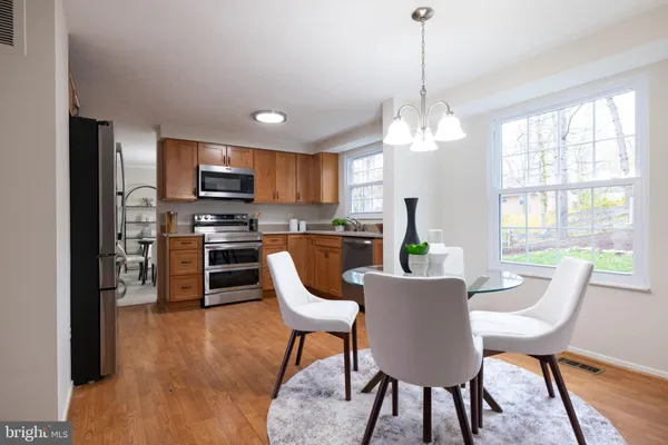 a kitchen with stainless steel appliances a stove microwave and sink