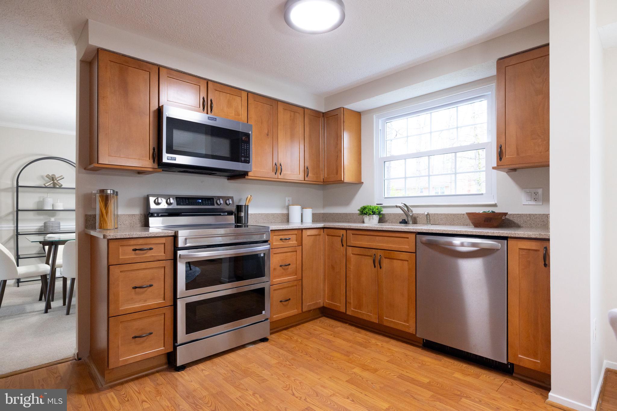 5755 Heming Avenue Springfield, VA 22151 - Photo 15 of 71 a kitchen with stainless steel appliances a stove microwave and sink