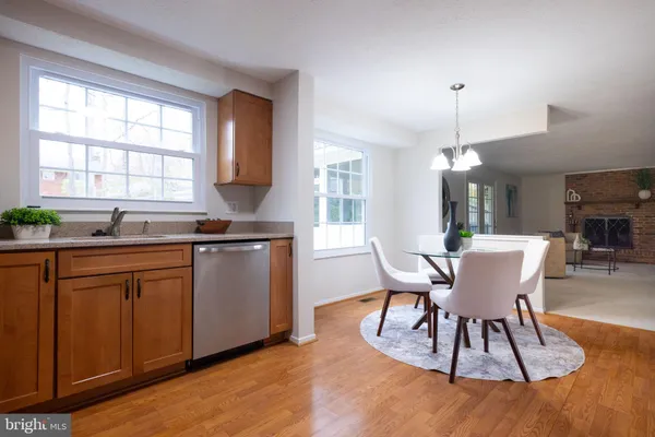 a kitchen with stainless steel appliances granite countertop wooden cabinets a sink and a stove