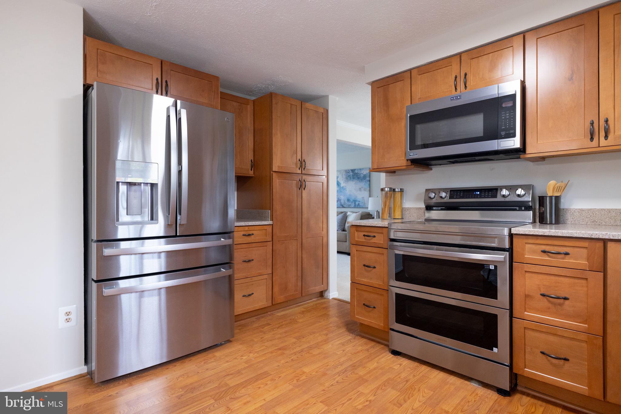 5755 Heming Avenue Springfield, VA 22151 - Photo 19 of 71 a kitchen with stainless steel appliances granite countertop a refrigerator stove and microwave