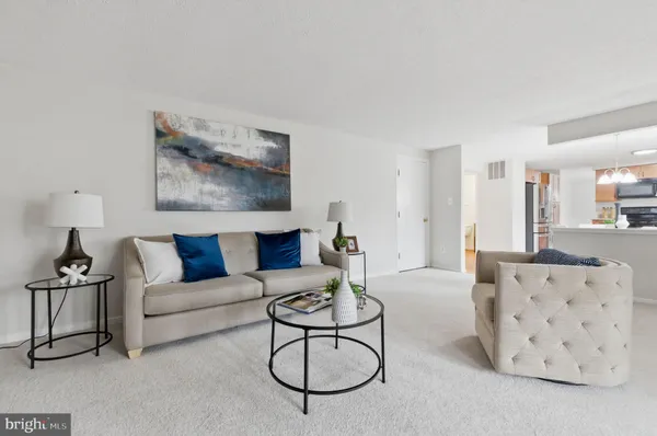a living room with furniture a flat screen tv and a window