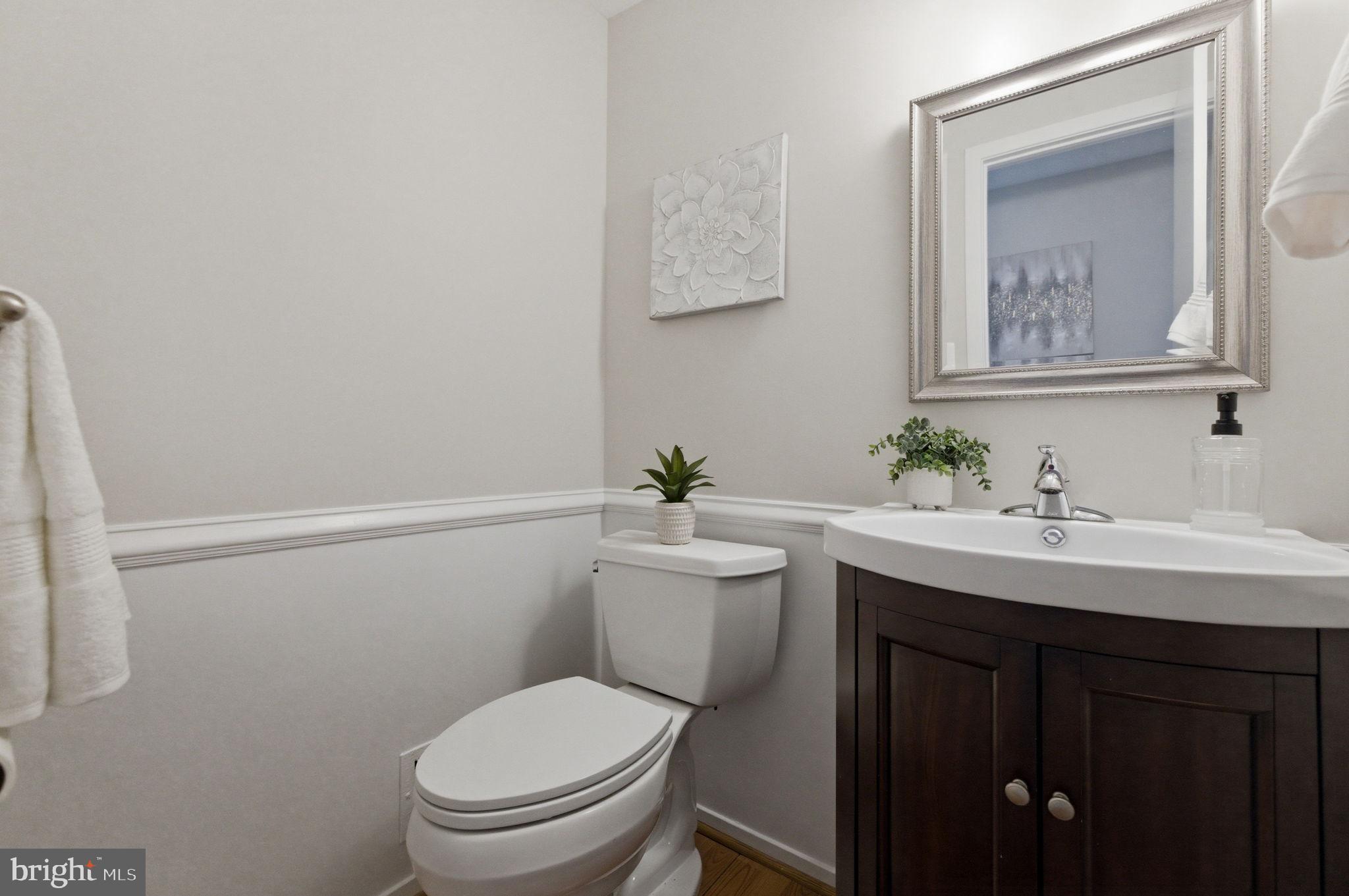 5755 Heming Avenue Springfield, VA 22151 - Photo 34 of 71 a bathroom with a toilet a sink and mirror