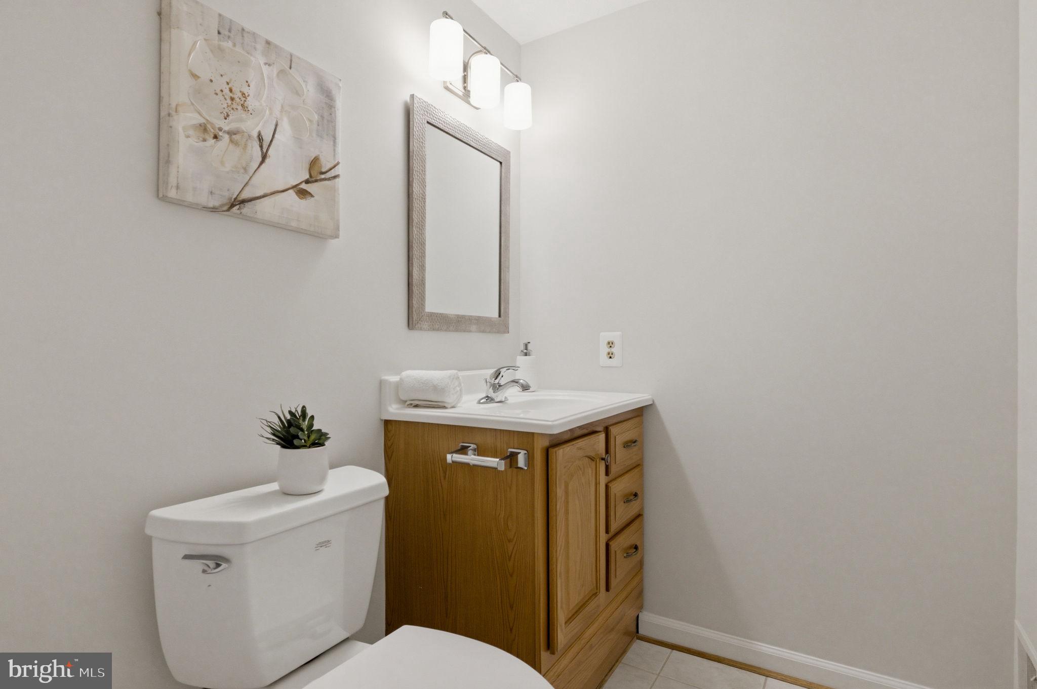 5755 Heming Avenue Springfield, VA 22151 - Photo 48 of 71 a bathroom with a sink mirror vanity and toilet