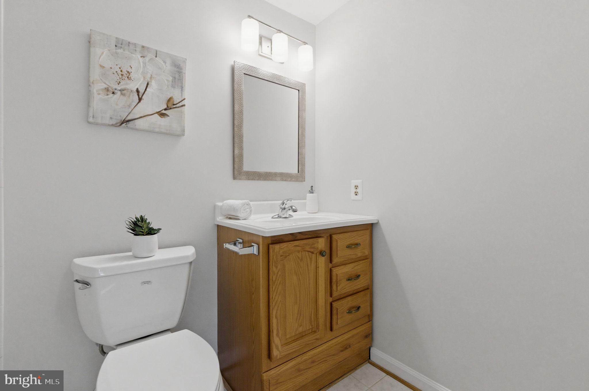 5755 Heming Avenue Springfield, VA 22151 - Photo 49 of 71 a bathroom with a toilet sink and mirror
