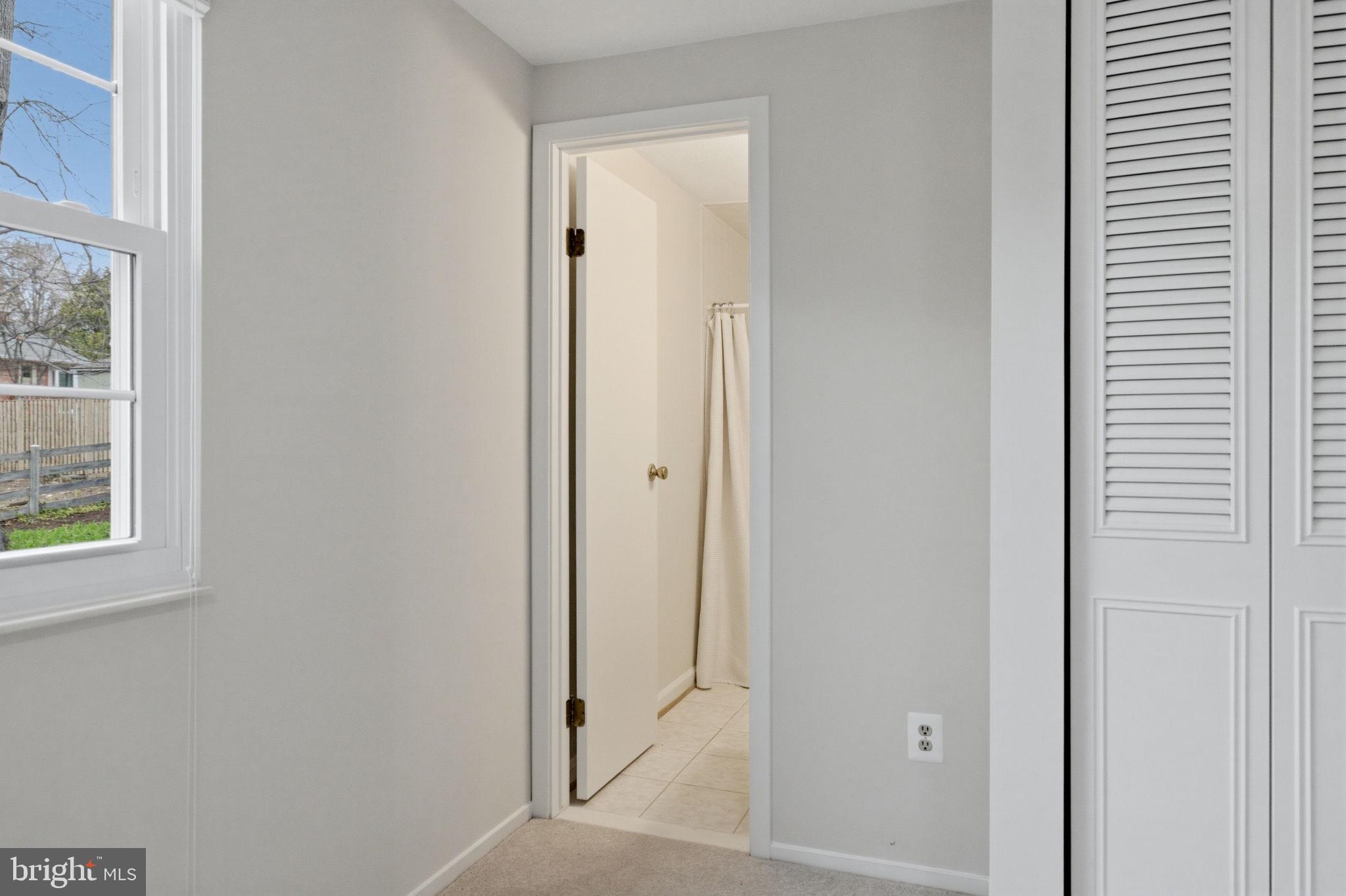 5755 Heming Avenue Springfield, VA 22151 - Photo 52 of 71 a view of a bathroom with a glass door and a window