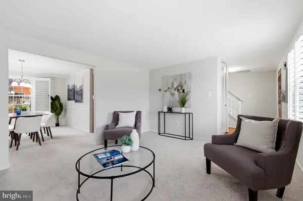 a living room with furniture a rug and a lamp