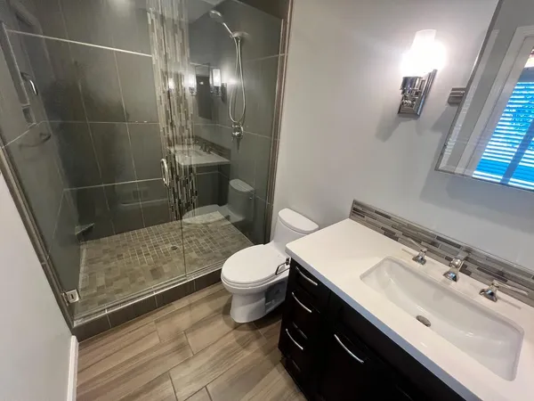 a bathroom with a sink toilet and shower