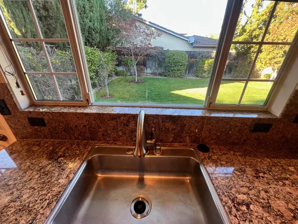 a bathroom with a sink and a large window