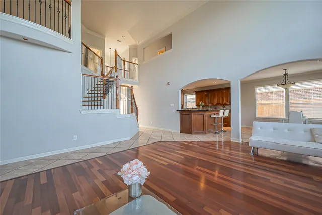 a living room with furniture and a wooden floor