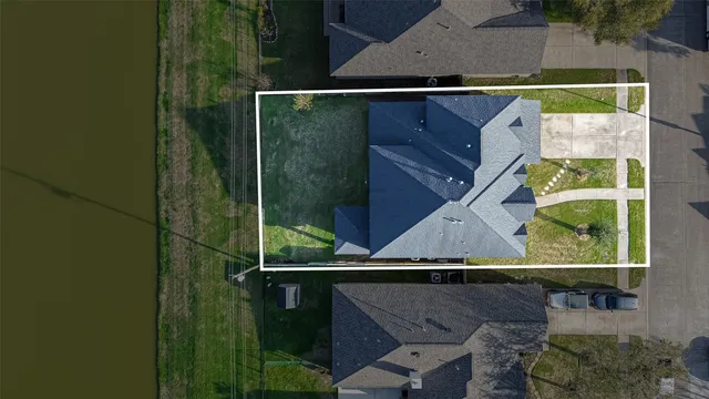 an aerial view of a houses with a yard