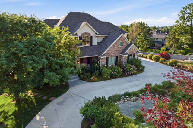 12308 Mariah Circle Draper, UT 84020 - Photo 259 of 293 Stately residence featuring a multi-gabled roof, stone and stucco facade, and dark louvered shutters